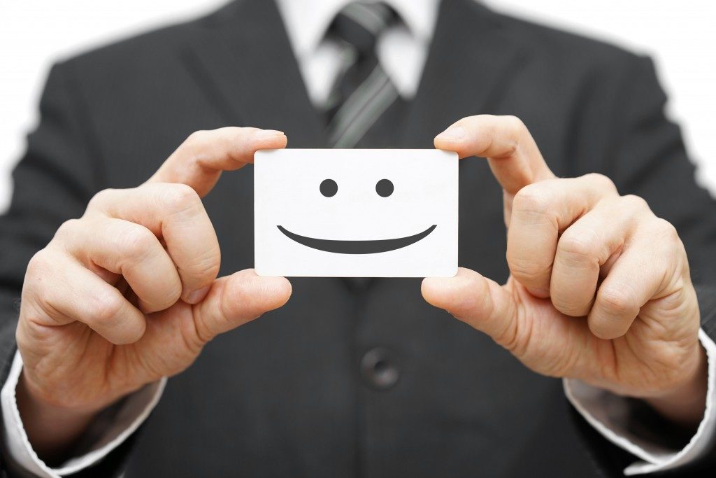 business man holding a card with happy face